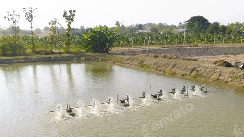 Preview: Water turbines machine on lake, pond or river in farm field in industry factory.