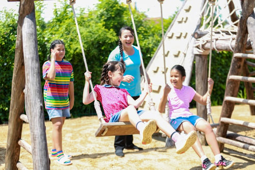 Preview: Group of happy children playing at playground