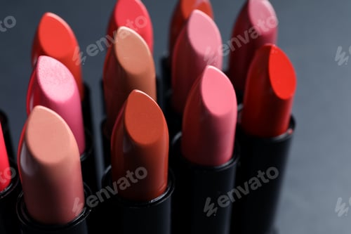 Preview: Set of different lipsticks on grey background, closeup. Cosmetic product