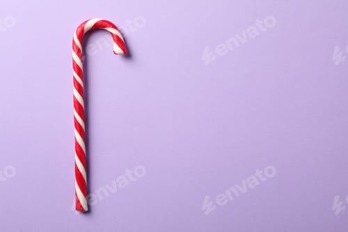 Preview: Sweet candy cane on color background, space for text