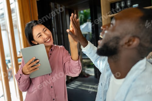 Preview: Successful couple working together, celebrating shared achievements. Positive collaboration