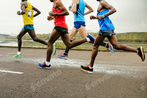 Preview: leading group runners dressed in bright sports clothes race along calm river, summer marathon