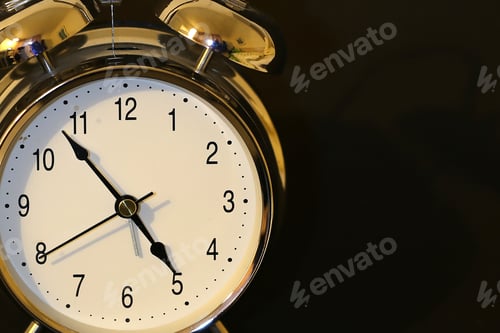 Preview: Closeup shot of an alarm clock on a black background