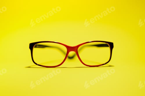 Preview: Red black glasses are on the yellow background. Concept idea.