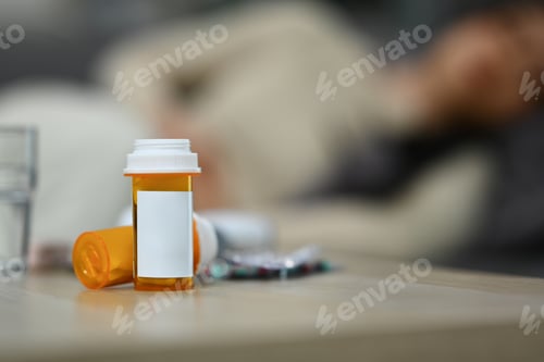 Preview: Pills bottles and glass of water on wooden table. Medicine, pharmacology, healthcare concept