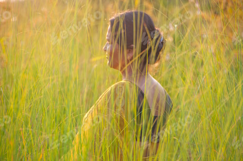 Preview: Blurred image of young woman in the meadow