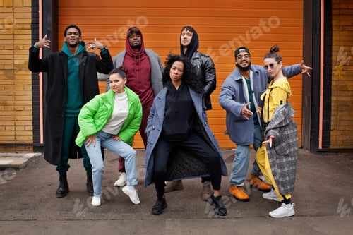 Preview: Multiracial group of young hipsters dance together on city street. Diverse Stylish people outdoor