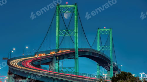 Preview: Night view of Vincent Thomas Bridge with light trails and moon.