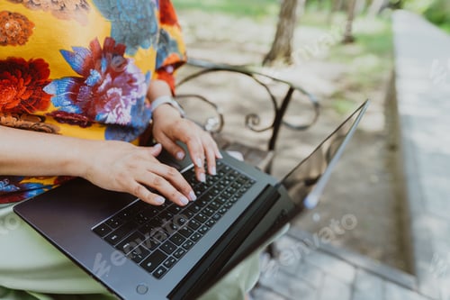 Preview: Office outdoors, close-up of female hands typing on a keyboard with laptop