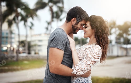 Preview: I feel your love deep in my heart. Shot of a young couple spending a romantic day at the beach.
