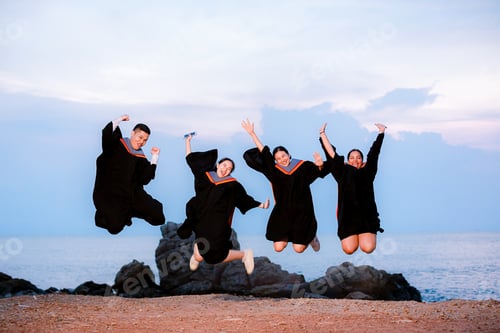 Preview: Graduation graduate jumping in the Air.