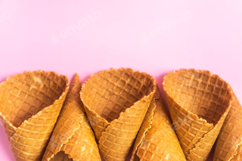 Preview: Empty waffle cones for ice cream on a pink background
