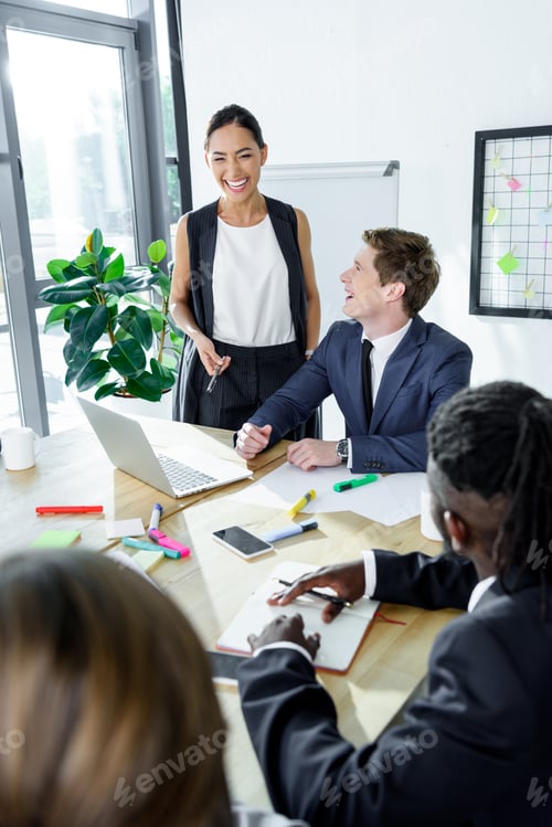 Preview: multiethnic happy business coworkers during meeting in office