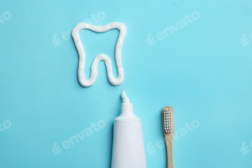 Preview: Tooth made of paste, tube, brush and space for text on color background, flat lay