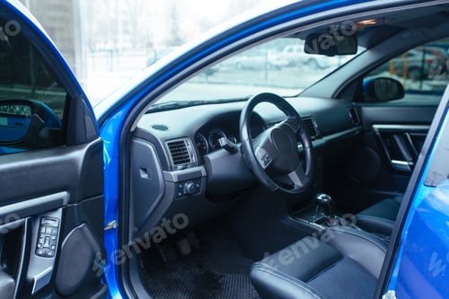 Preview: the interior of the vehicle with the front door open , the steering wheel seat
