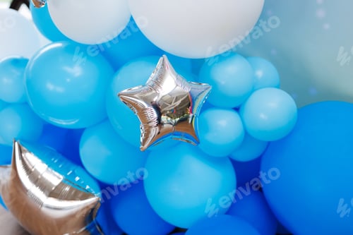 Preview: Close-up of multicolored latex balloons with silver stars. Holiday decor.