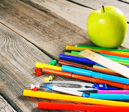 Preview: School tools. On wooden background.