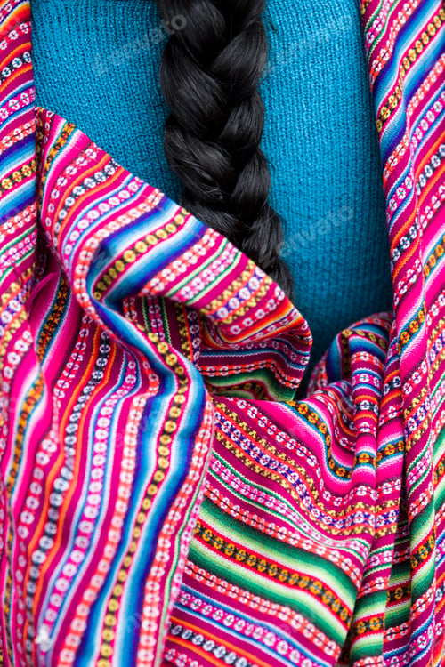 Preview: Peruvian woman with the long black hair braids, wearing traditional colorful clothes