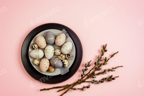 Preview: Plates with painted Easter eggs and willow branches on pink background.