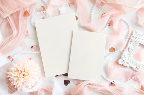 Preview: Cards near pink decorations, hearts and silk ribbons on white table top view, mockup