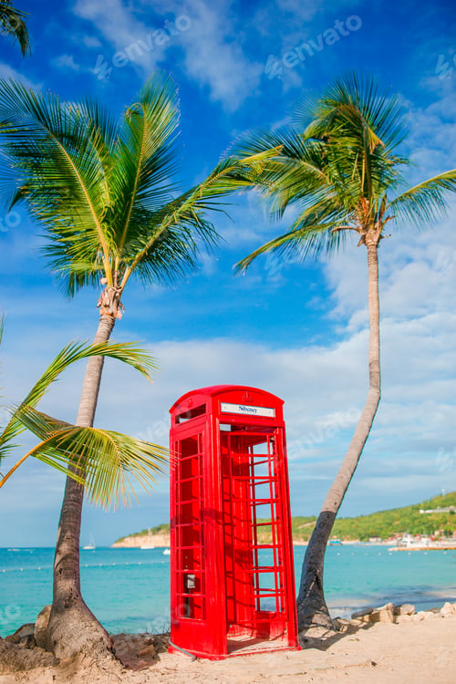 Preview: Red phone booth in Dickenson's bay Antigua. Beautiful landscape with a classic phone booth on