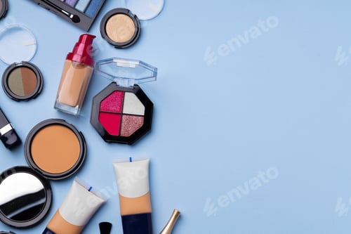 Preview: Complexion make up products and brush on blue background
