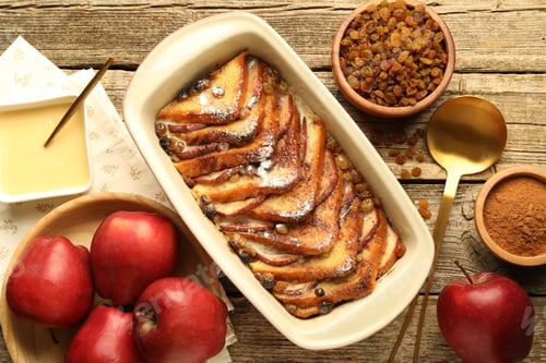 Preview: Flat lay composition with tasty bread pudding on wooden table