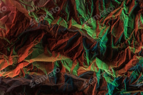 Preview: top view of crumpled paper with green colorful lighting in darkness