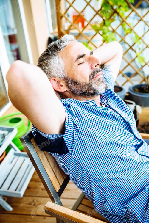 Preview: Portrait of man relaxing on his balcony