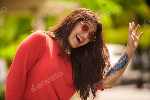 Cheerful Woman Smiles in the Sunlight Outdoors