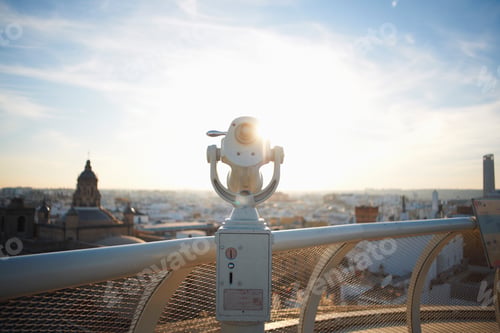 Preview: Coin operated telescope and sunlit cityscape, Seville, Andalusia, Spain