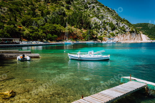 Preview: Beautiful tranquil sunny scenery of lovely greek harbor, blue sea with crystal clear water. Summer