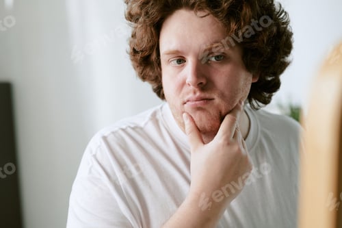 Preview: Portrait of Pensive Young Man Touching His Chin