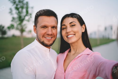 Preview: Happy couple taking selfie on street