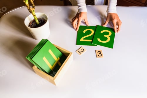 Preview: Montessori student hands using sensory materials in a school.