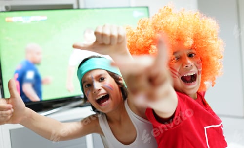 Preview: Family With Football Watching Soccer World Cup Game On Tv In Living Room