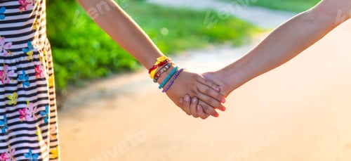 Preview: Children walk hand in hand. Selective focus.