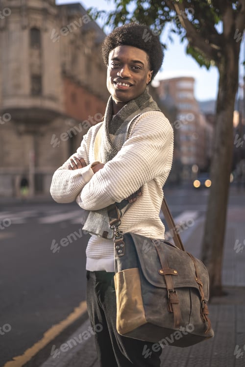 Preview: Portrait of happy african american hipster student man smiling at camera in city street. Lifestyle.