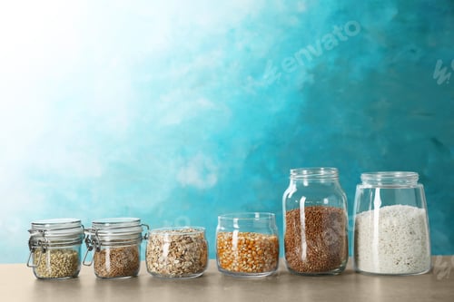 Preview: Jars with different types of grains and cereals on table
