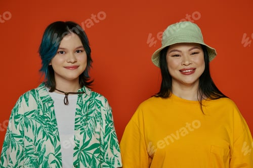 Preview: Duo in crimson: asian mother and teen daughter