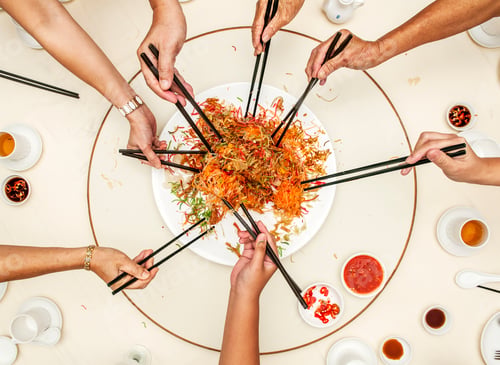 Preview: Hands using chopsticks to take food on plate