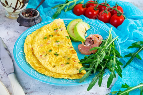 Preview: Fried omelette with ham, onion and herbs. Breakfast with scrambled eggs