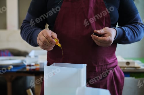 Preview: Artisan prepares resin mix, adding color to the clear medium. It's a step that brings vibrancy to