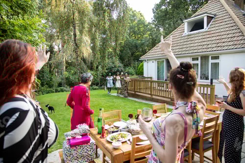 Preview: Friends and family arriving at a summer garden party