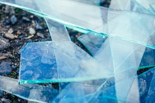 Preview: a small pile of broken glass lying on the asphalt