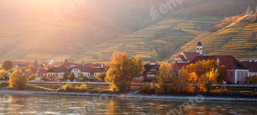 Preview: autumn view of small austrian village on a river bank