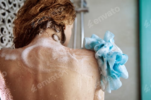 Preview: Woman taking a shower in bathroom