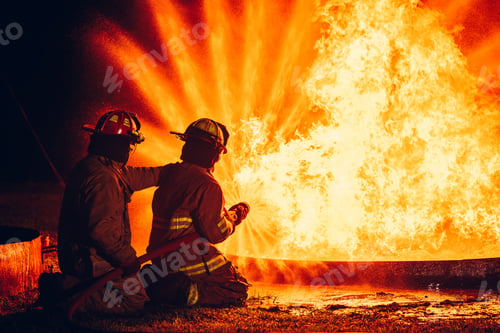 Preview: Fearless Firefighters Battling Blaze with Water and Extinguishers.