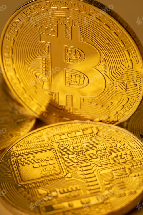 Preview: Closeup of gold bitcoin on yellow backgound