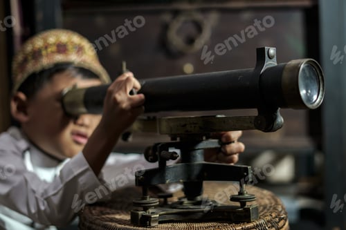 Preview: Smart school Asian boy studying old brass theodolite at the Aceh Pedir Museum